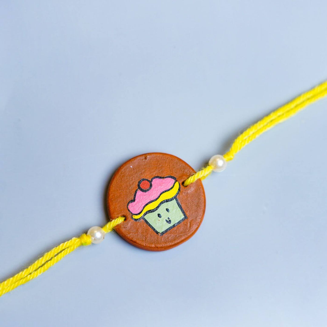 Personalized Food Theme Terracotta Rakhi With Roli Chawal 5 - Close-up of Rakhi centerpiece