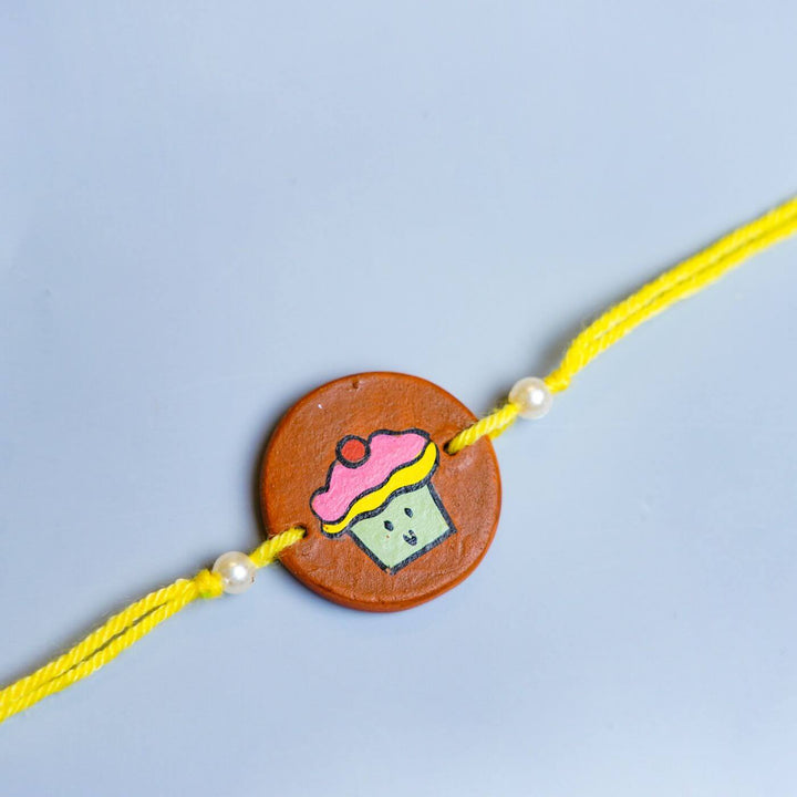 Personalized Food Theme Terracotta Rakhi With Roli Chawal 5 - Close-up of Rakhi centerpiece