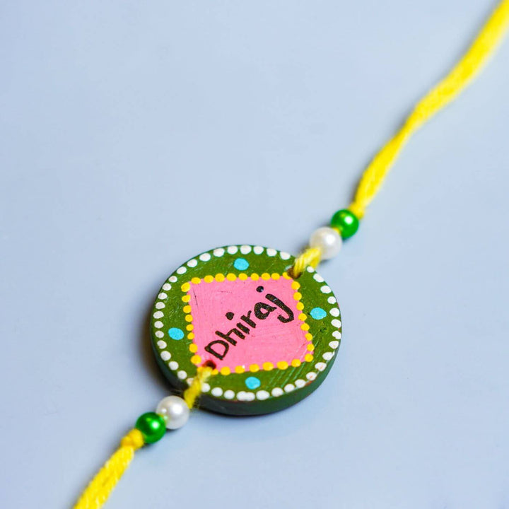 Personalized Terracotta Rakhi Hamper With Caricature 1 - Rakhi Close-up on Surface