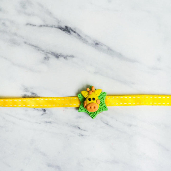 Handmade Porcelain Clay Themed Rakhi 8 - Flat Lay with Giraffe Charm