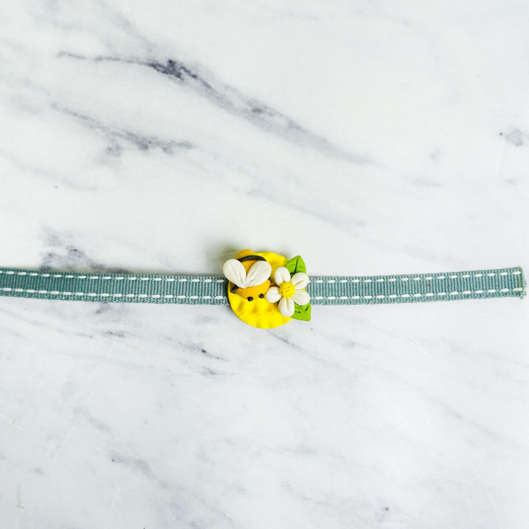 Handmade Porcelain Clay Themed Rakhi 12 - Close-up of Bee Rakhi