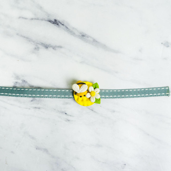 Handmade Porcelain Clay Themed Rakhi 12 - Close-up of Bee Rakhi