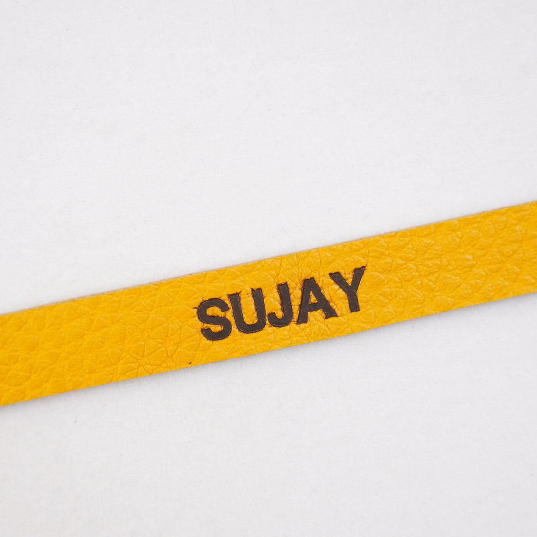 Personalized Rakhi In Genuine Leather - Close-up of Personalization Text