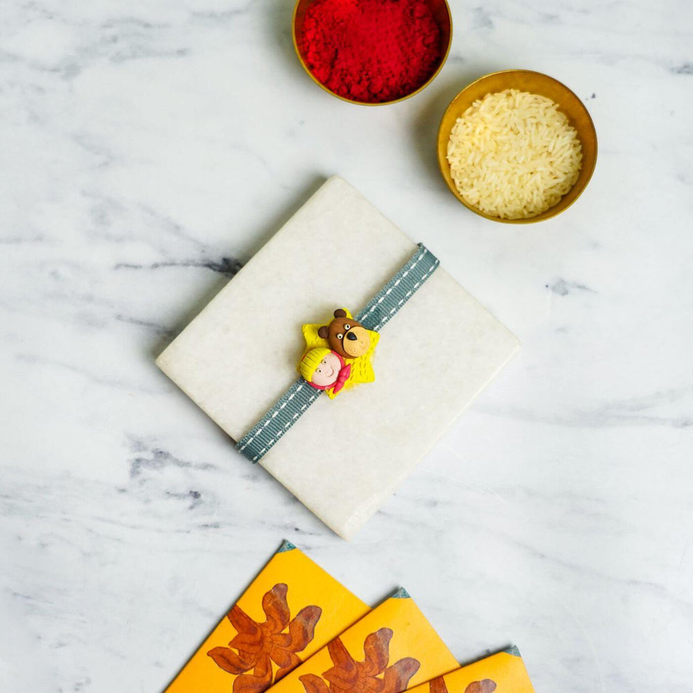 Handmade Porcelain Clay Themed Rakhi 3 - Flat lay with gift and decor