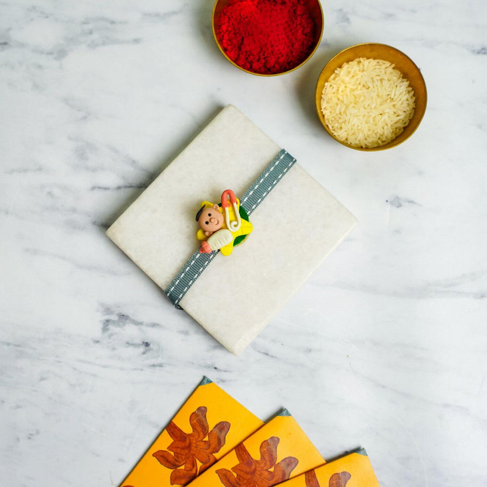 Handmade Porcelain Clay Themed Rakhi 12 - Wrapped Gift with Rakhi Styling