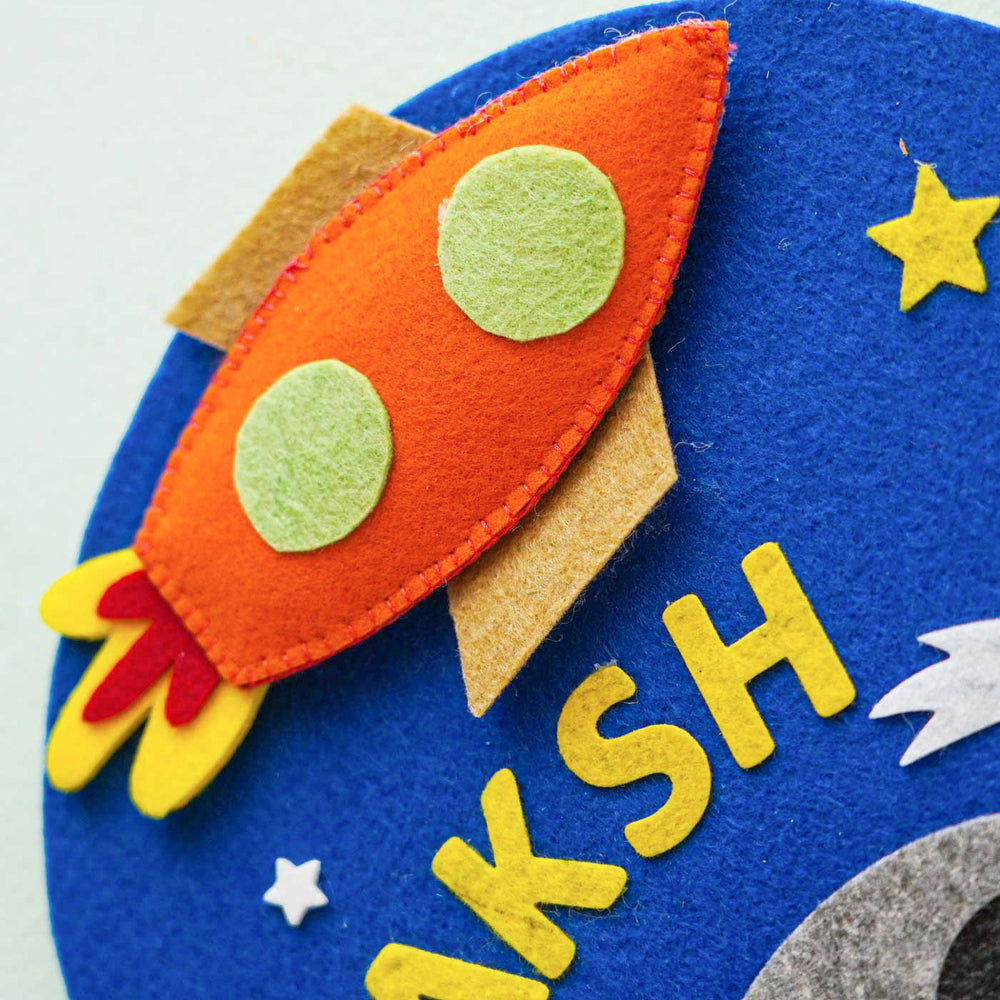 Personalized Handmade Space Theme Felt Hoop Name Plate - Close-up on Felt Rocket Detail