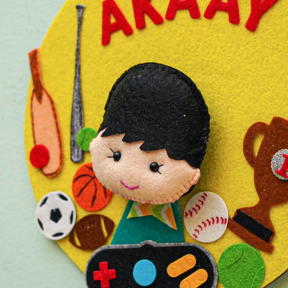 Personalized Handmade Boy And Sports Theme Felt Hoop Name Plate - Close-up of Character and Sports Icons