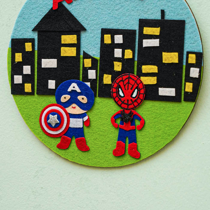 Personalized Handmade Superhero Theme Felt Hoop Name Plate - Front View Hanging on Wall
