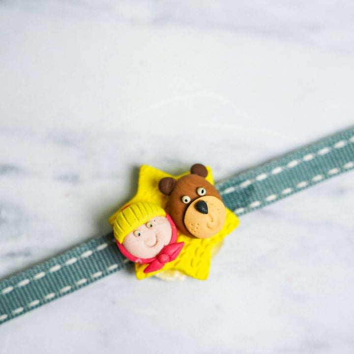 Handmade Porcelain Clay Themed Rakhi 8 - Close-up of Girl and Bear Charm