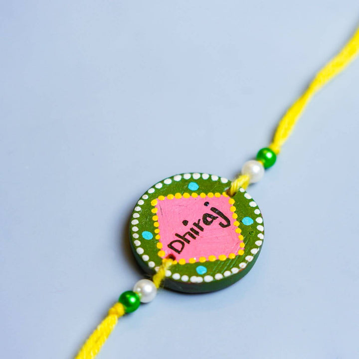 Personalized Terracotta Rakhi Coffee Mug Set With Roli Chawal 2 - Rakhi Close-up with Name Detail