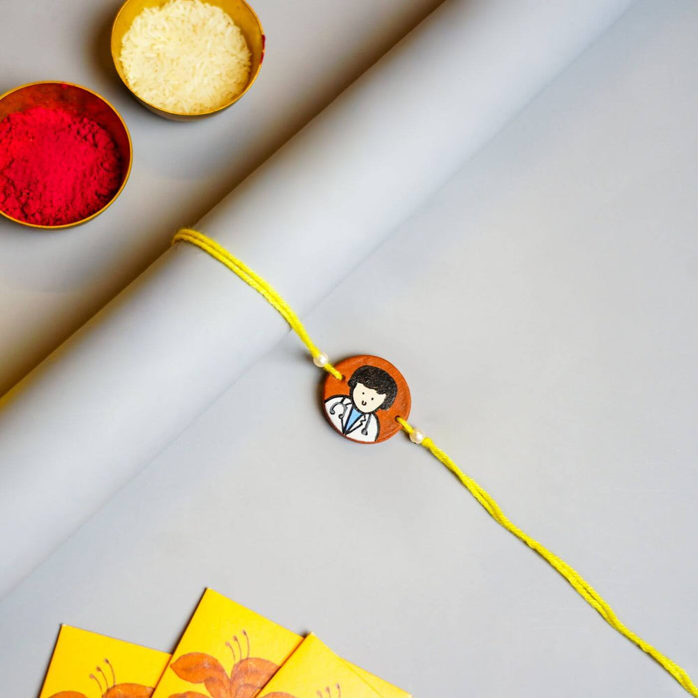 Personalized Profession Theme Terracotta Rakhi With Roli Chawal 1 - Flat lay with festive items