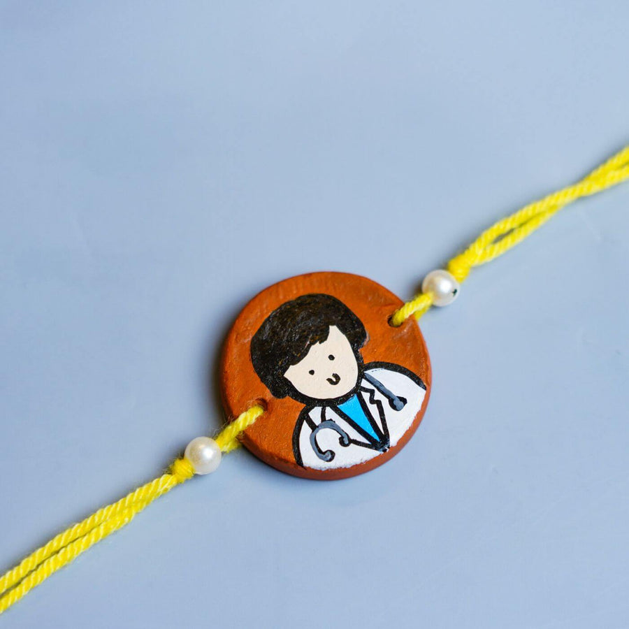 Personalized Profession Theme Terracotta Rakhi With Roli Chawal 1 - Close-up of Rakhi charm