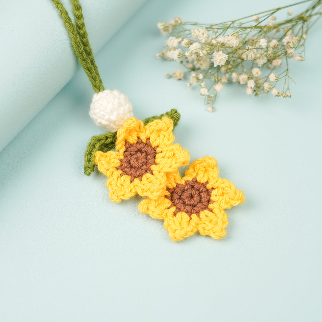 Handmade Crochet Sunflower Lumba Rakhi For Bhabhi With Roli Chawal - Close-up of crochet sunflower pendant