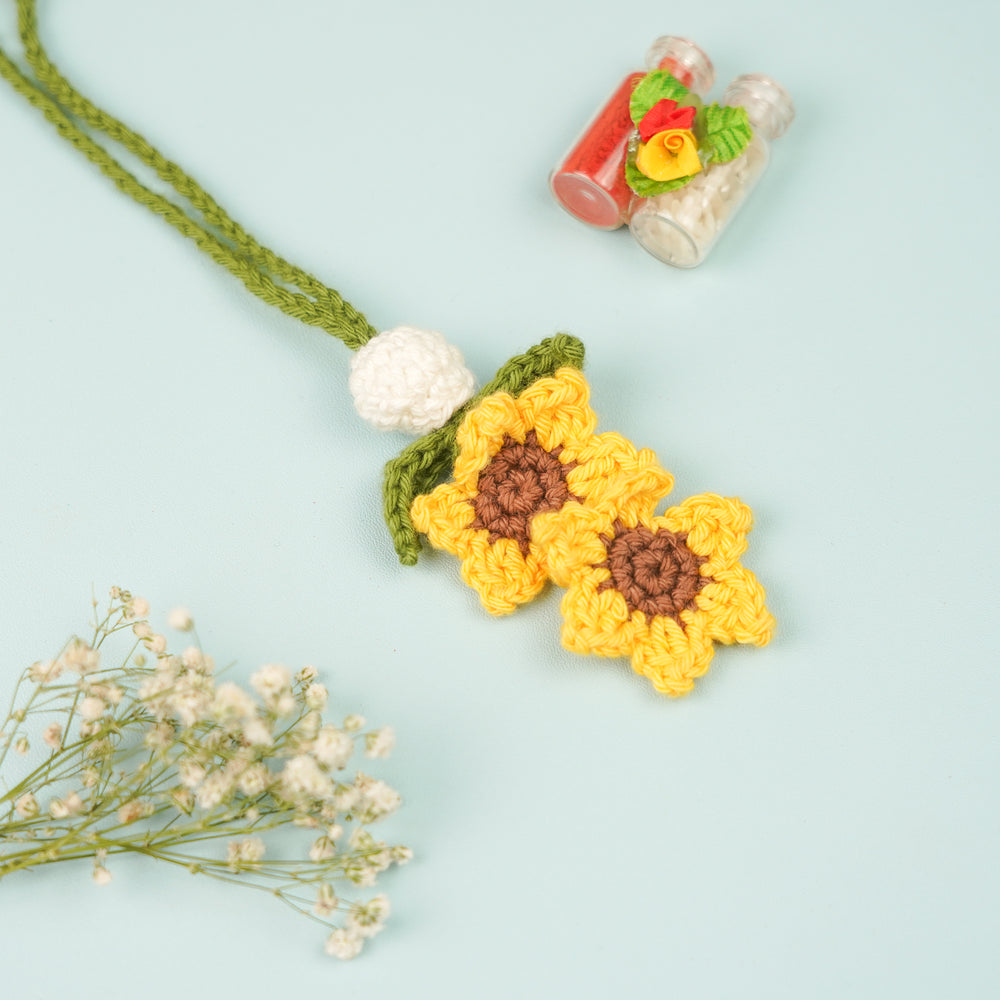 Handmade Crochet Sunflower Lumba Rakhi For Bhabhi With Roli Chawal - Top view with additional decor