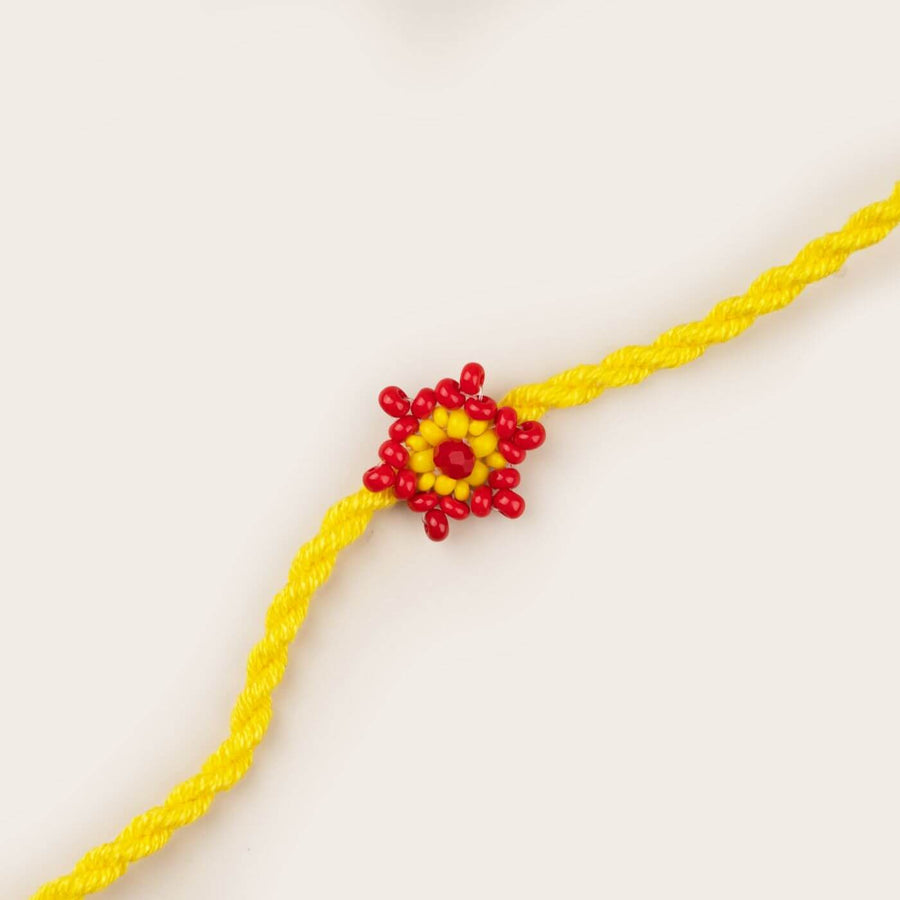 Handcrafted Glass Beads Tara Rakhi 4 - Close-up of Yellow Flower Bead