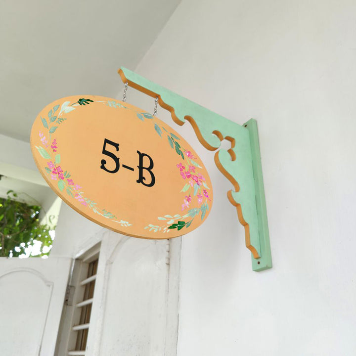Hand Painted Oval Hanging Floral Name Plate 9 - Side View Hanging on Wall Bracket