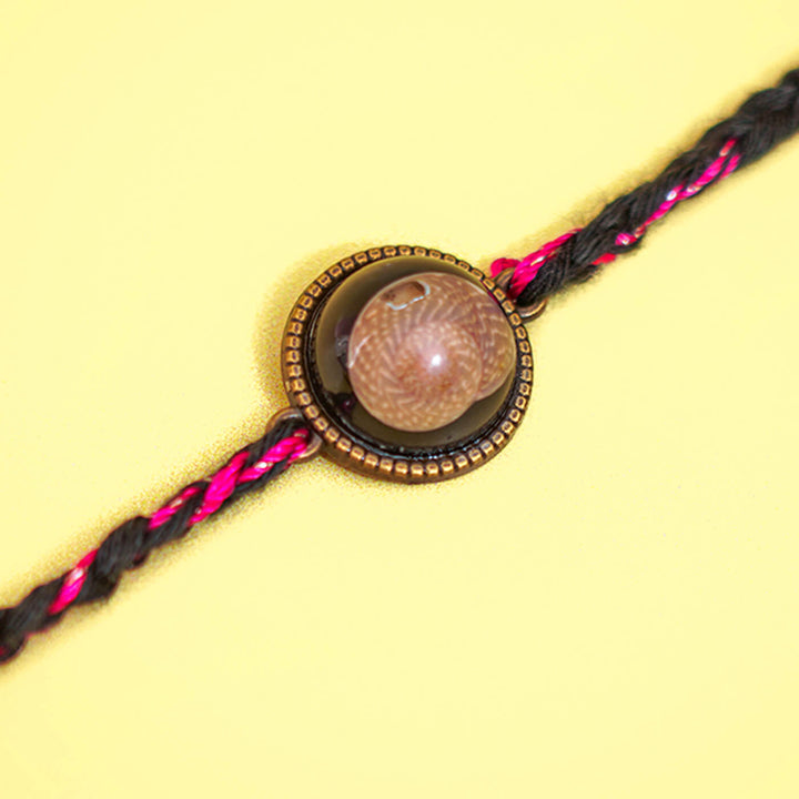 Bio Resin Brown Shell Rakhi White - Close-up of conical shell centerpiece