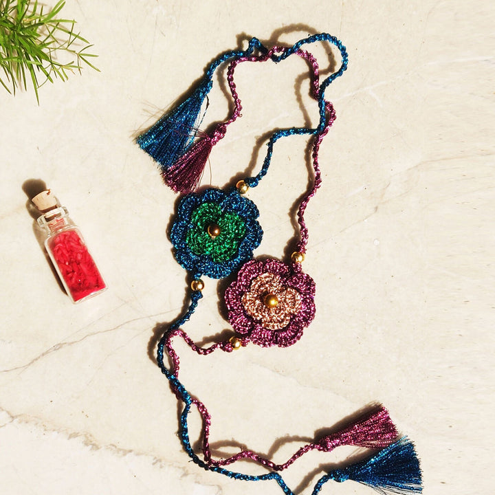 Double Flower Zari Rakhi Set Of 2 - Flat Lay with Two Floral Rakhis