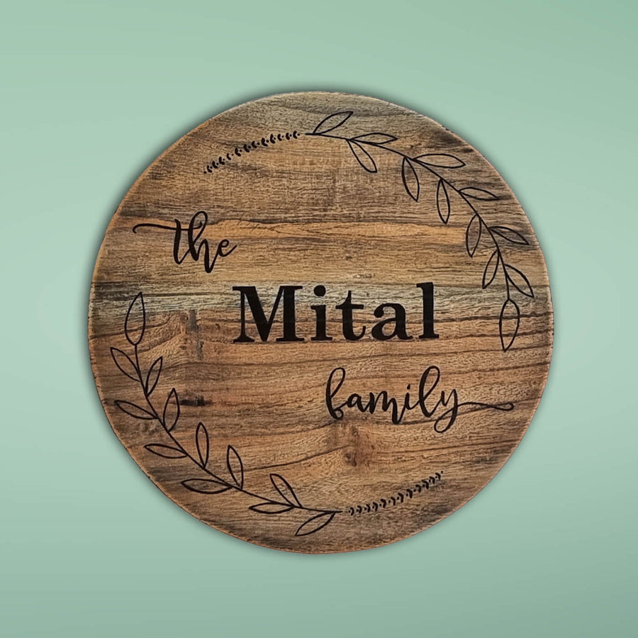 Round Rustic Wood Hand Painted Family Name Plate - Front View on Wall Background