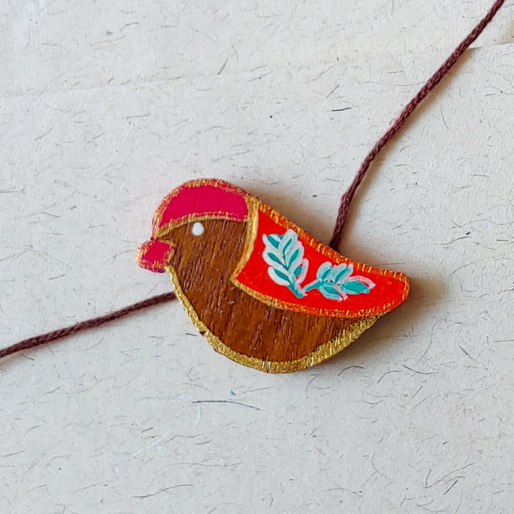 Handpainted Wooden Rakhi Mountain - Close-up on Colorful Bird Bracelet