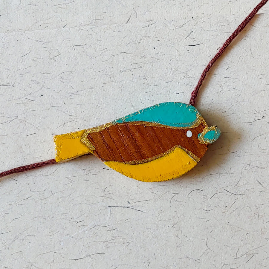 Handpainted Wooden Rakhi Mini Bird 1 - Close-up of bird bracelet charm