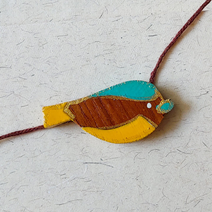 Handpainted Wooden Rakhi Hippo - Front View of Bird Wristband
