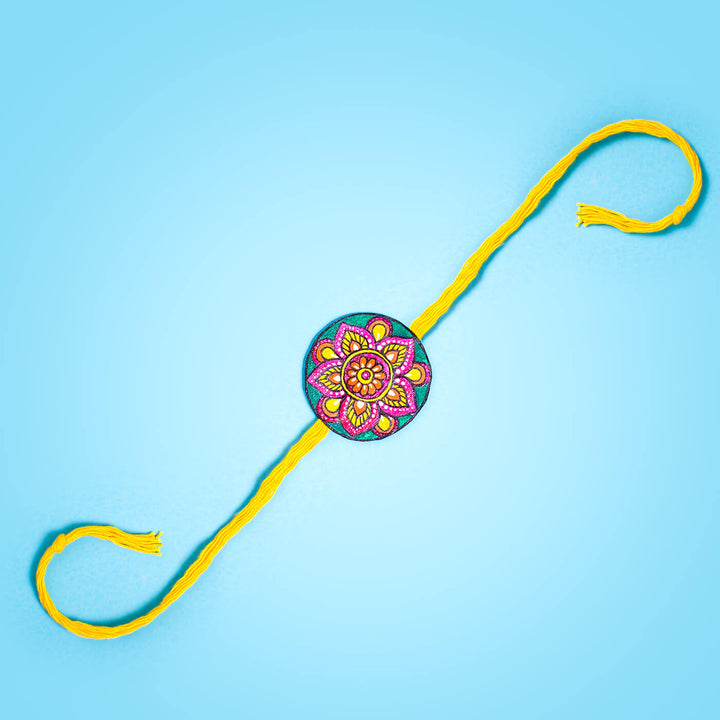 Hand Painted Seed Rakhi Yellow Unbraided - Flat Lay with Yellow Thread