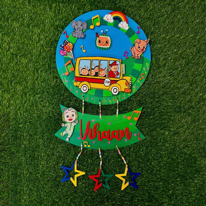 Hand Painted Cocomelon Theme Personalised Hanging Kids Name Plate - Front View Hanging on Grass