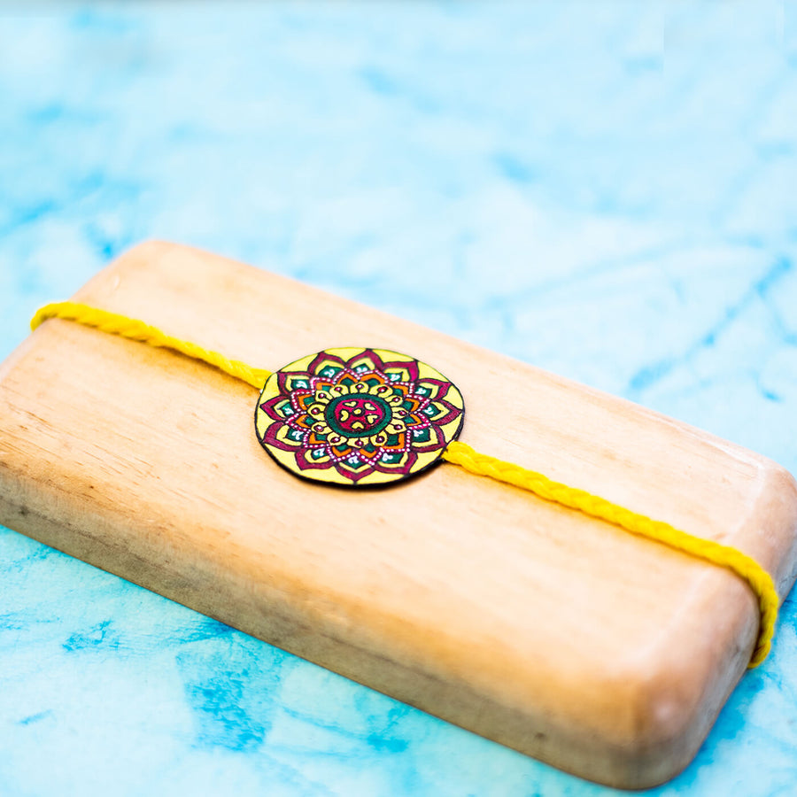 Hand Painted Seed Rakhi Yellow - Close-up on Decor Detail