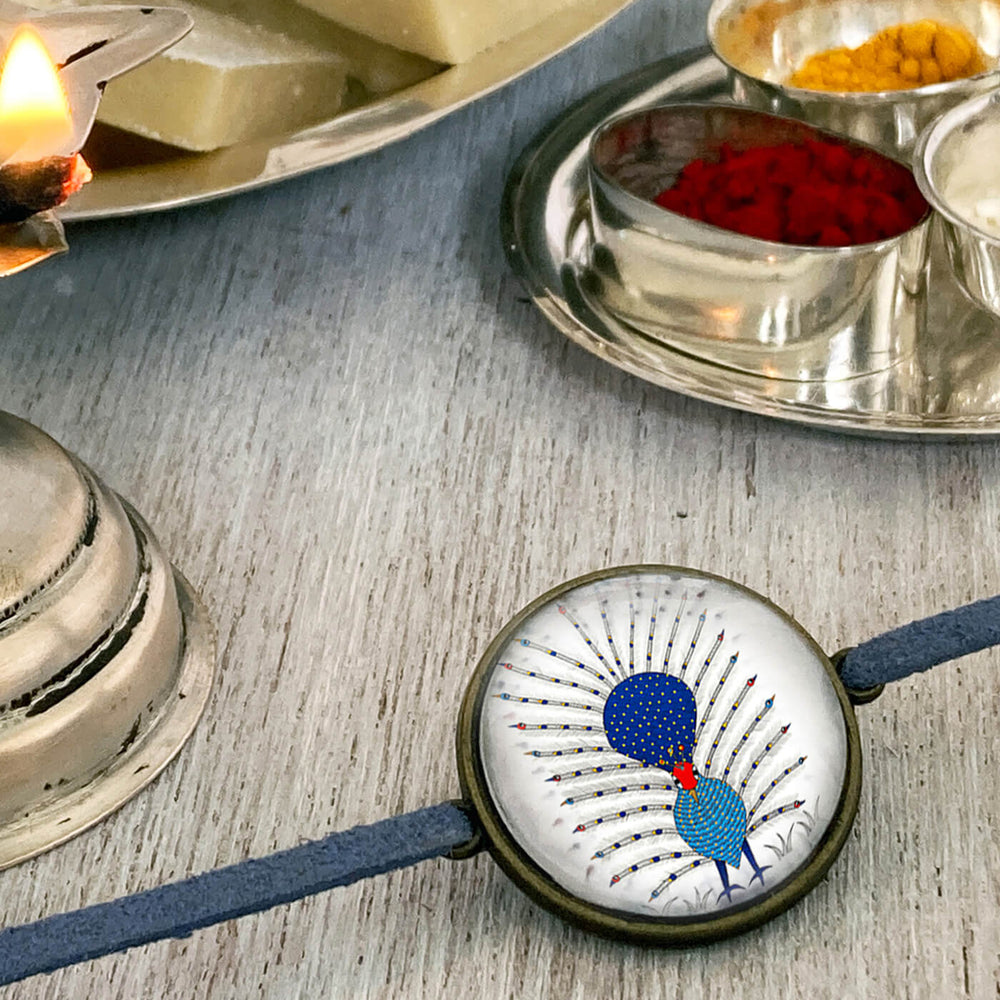 Gond Peacock Handcrafted Folkart Rakhi - Side View with Background Props