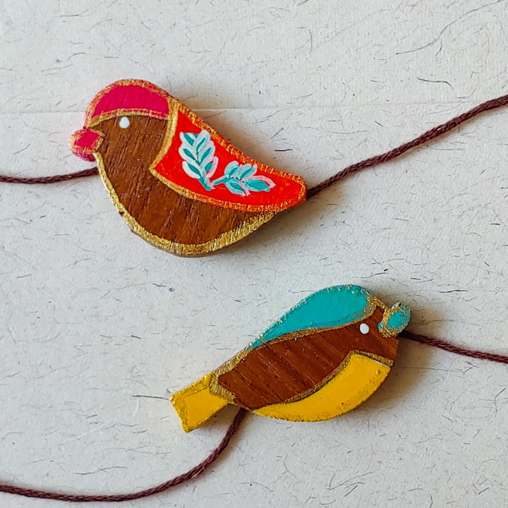 Handpainted Wooden Rakhi Set Of 2 Dogs - Bird Shaped Rakhi Front View