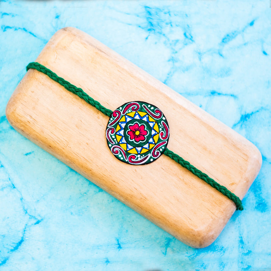 Hand Painted Seed Rakhi Green - Mounted on Wooden Display Block
