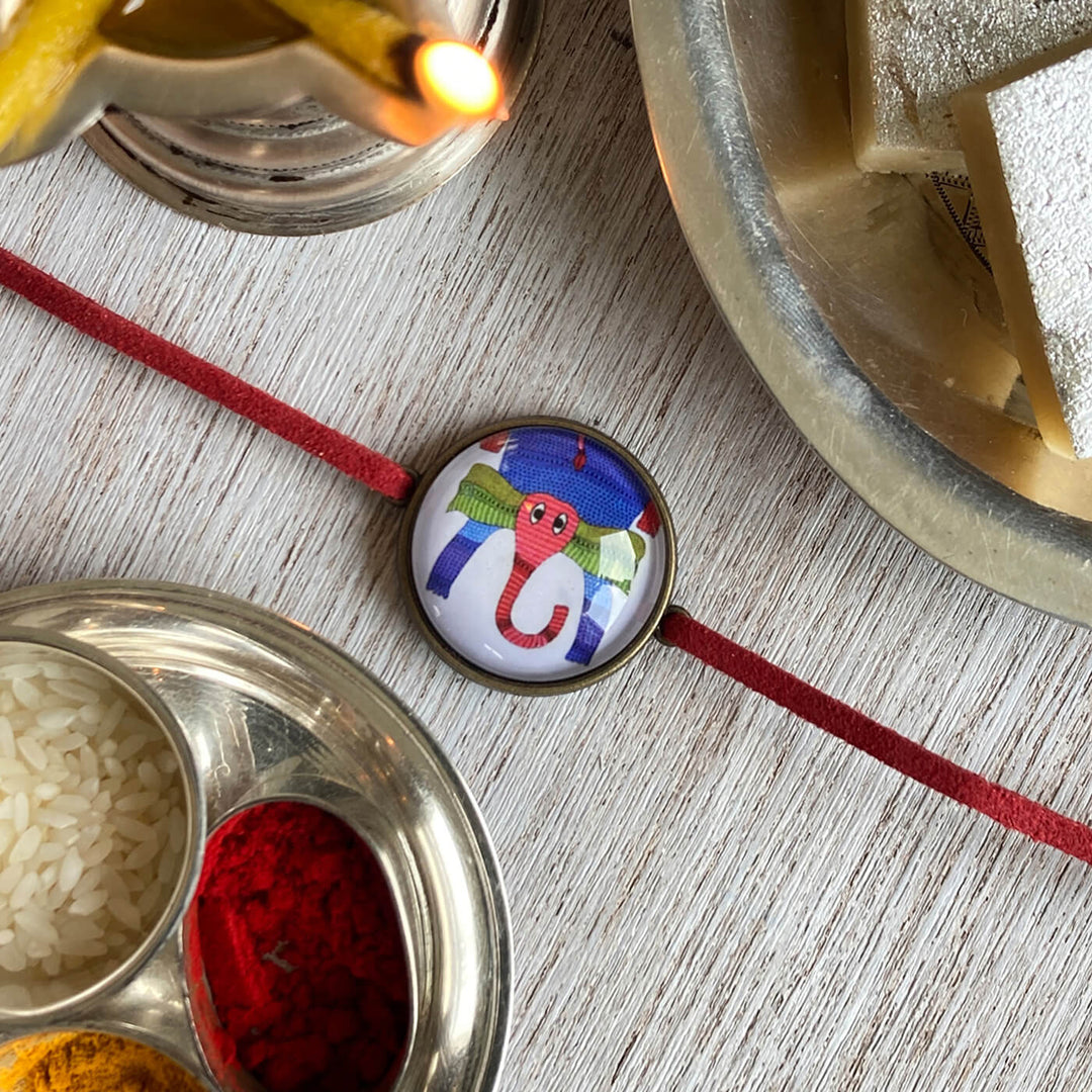 Gond Elephant Handcrafted Folkart Rakhi - Top View with Festival Setup