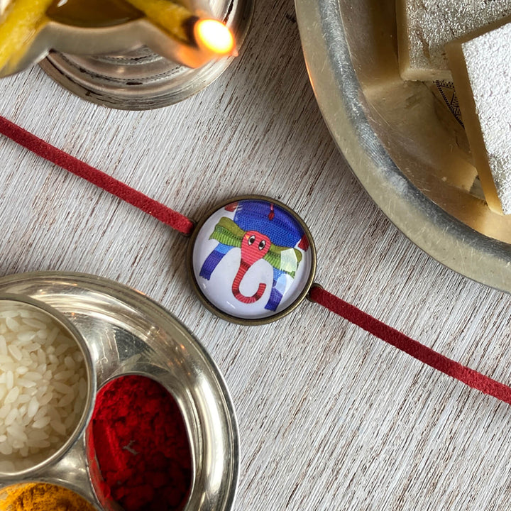 Gond Elephant Handcrafted Folkart Rakhi - Top View with Festival Setup
