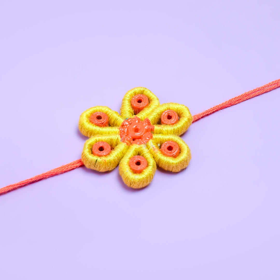 Paper Mache Rakhi Yellow Blossom - Rakhi Flower on Purple Background