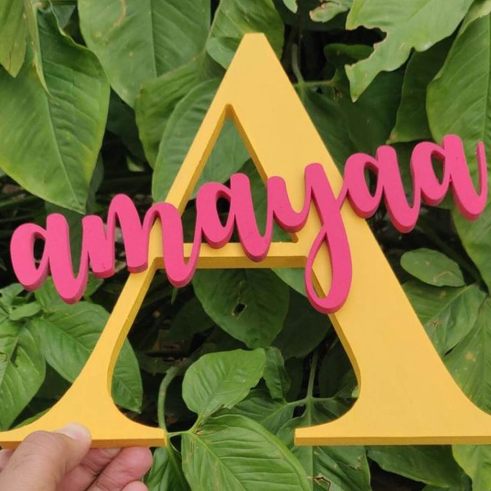Red And Yellow Hand Painted Mdf Monogram Initial Name Plate - Handheld Front View with Leaves Background