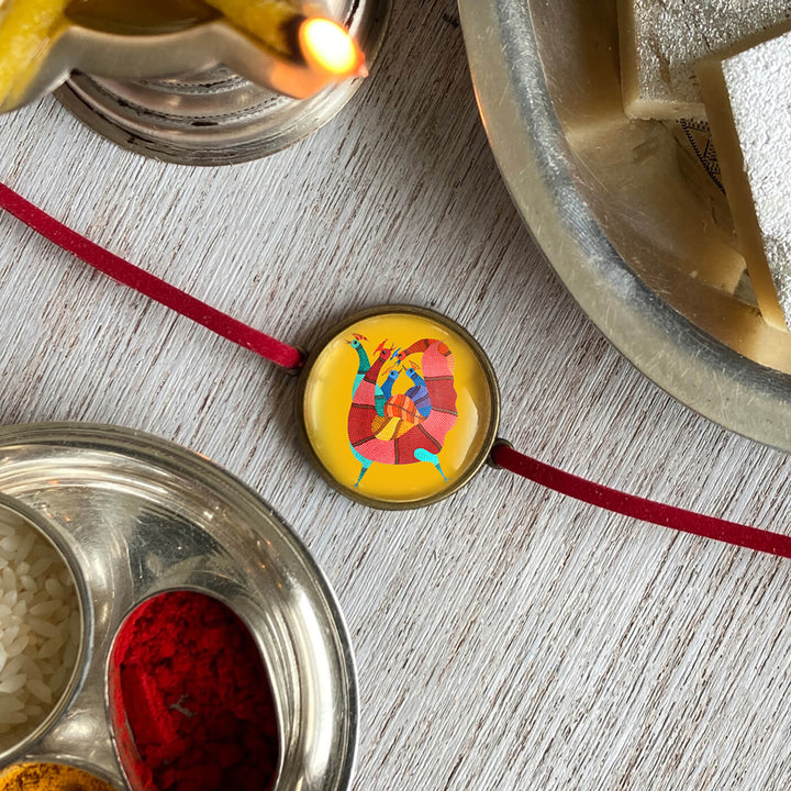 Gond Rooster Handcrafted Folkart Rakhi - Detailed Side View with Rangoli Elements
