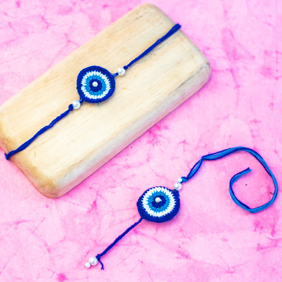 Bhaiyya Bhabhi Lumba Rakhi Set Evil Eye - Displayed with wooden block