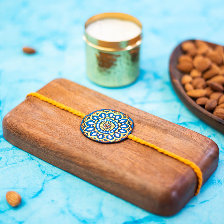 Hand Painted Seed Rakhi Orange - On Wooden Display Block