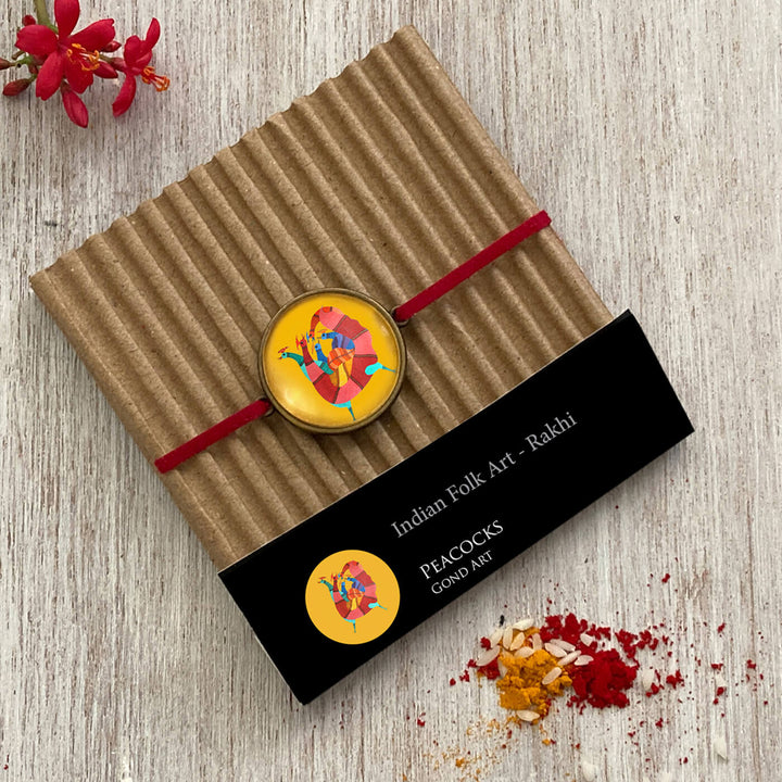 Gond Rooster Handcrafted Folkart Rakhi - Packaged Product on Cardboard Backing