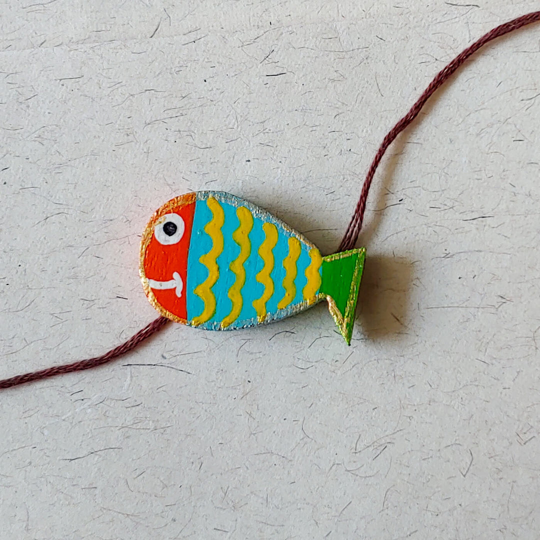 Handpainted Wooden Rakhi Mustache - Close-up on Fish Bracelet