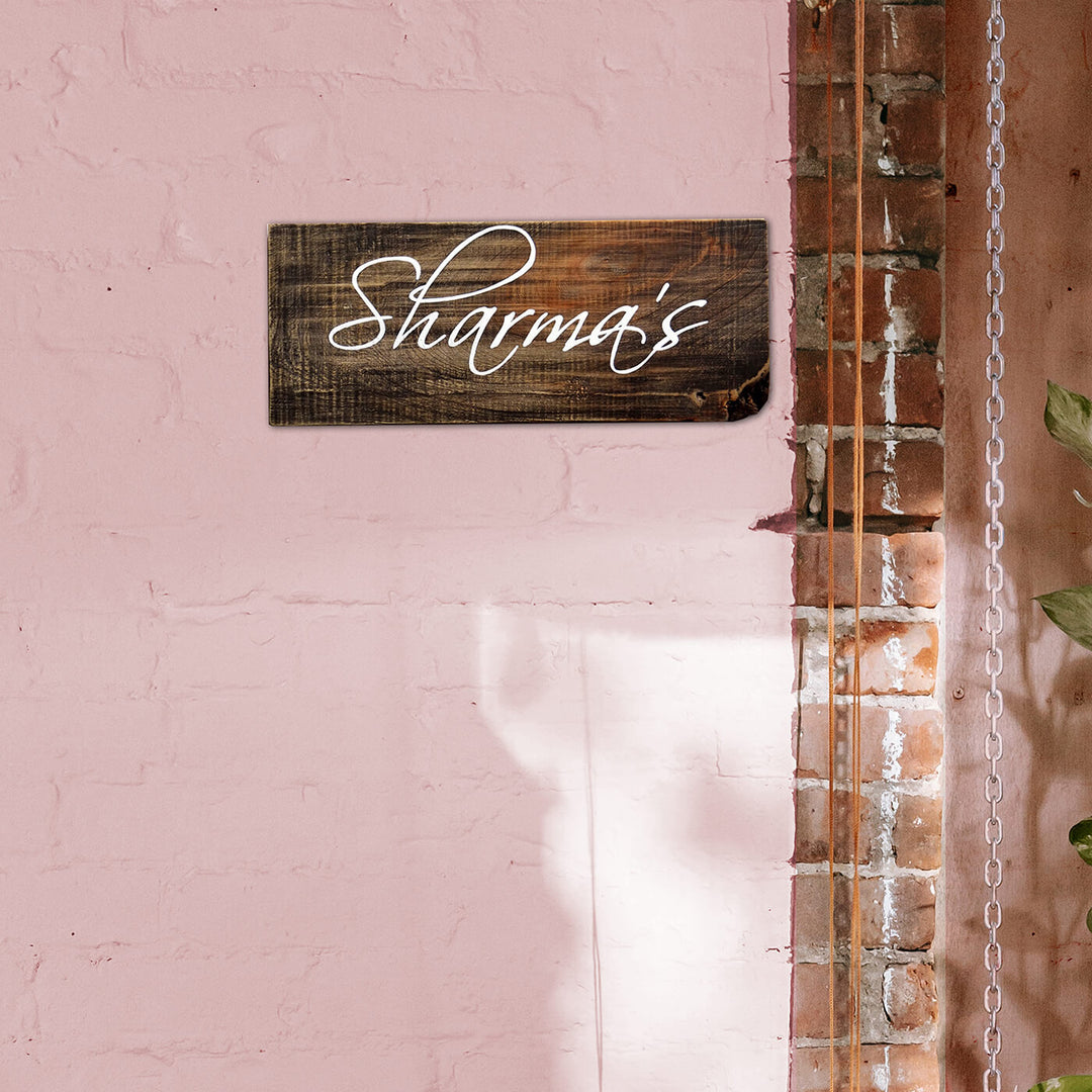 Rustic Wood Hand Painted Family Name Plate - Mounted on Pink Brick Wall