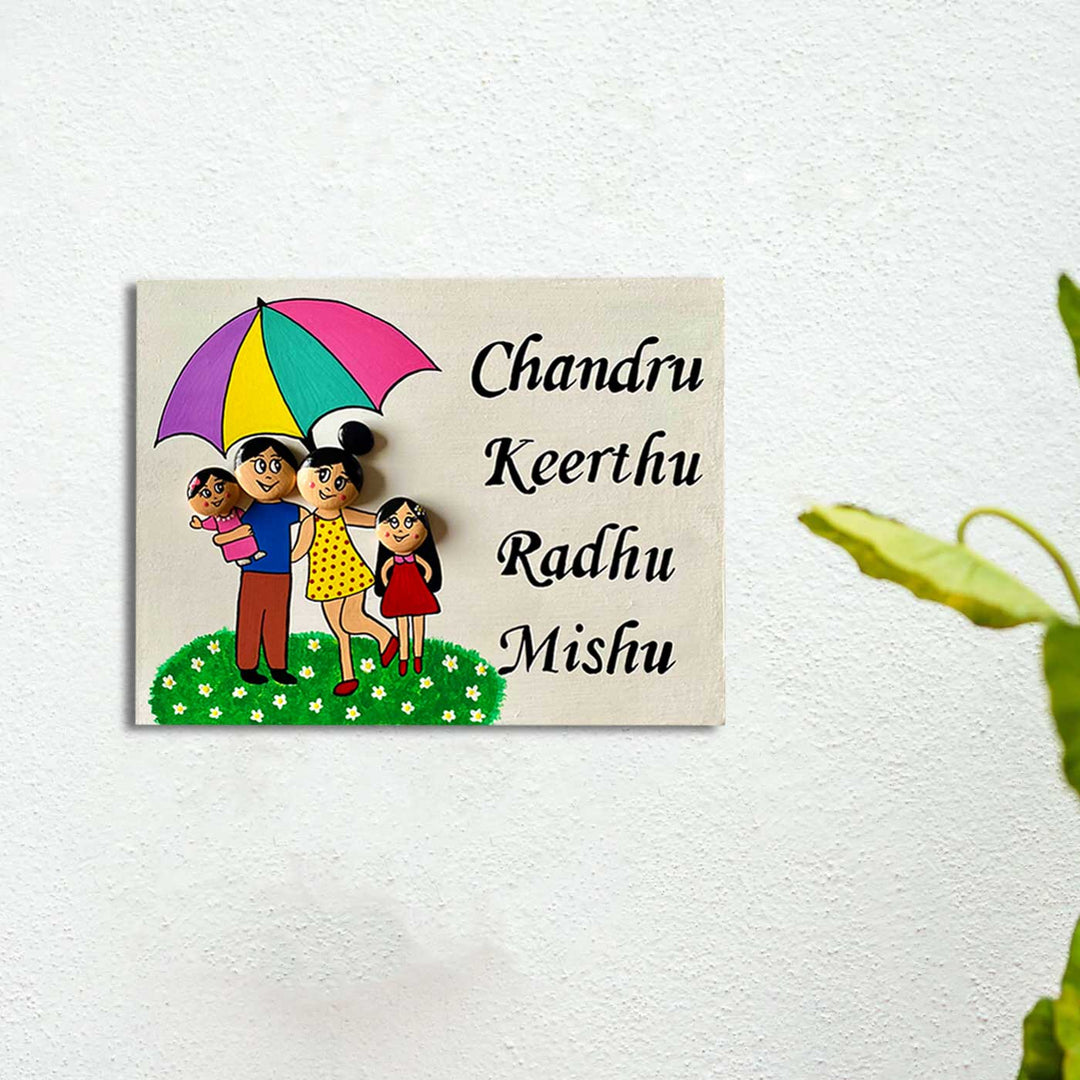 Handpainted Clay Pebble Name Plate For Family 6 - Mounted on White Wall Close-up