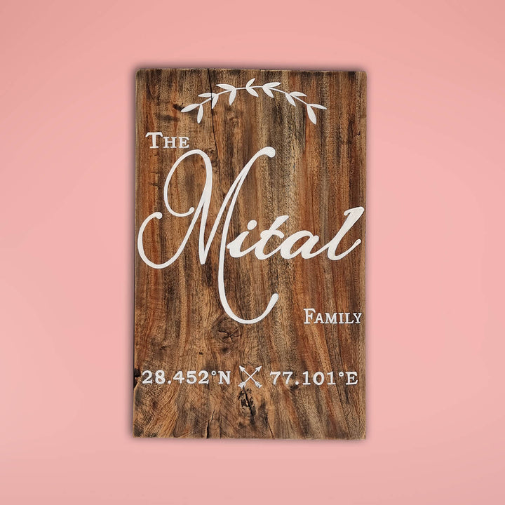 Rustic Wood Hand Painted Family Name Plate With Co Ordinates - Front View on Pink Background