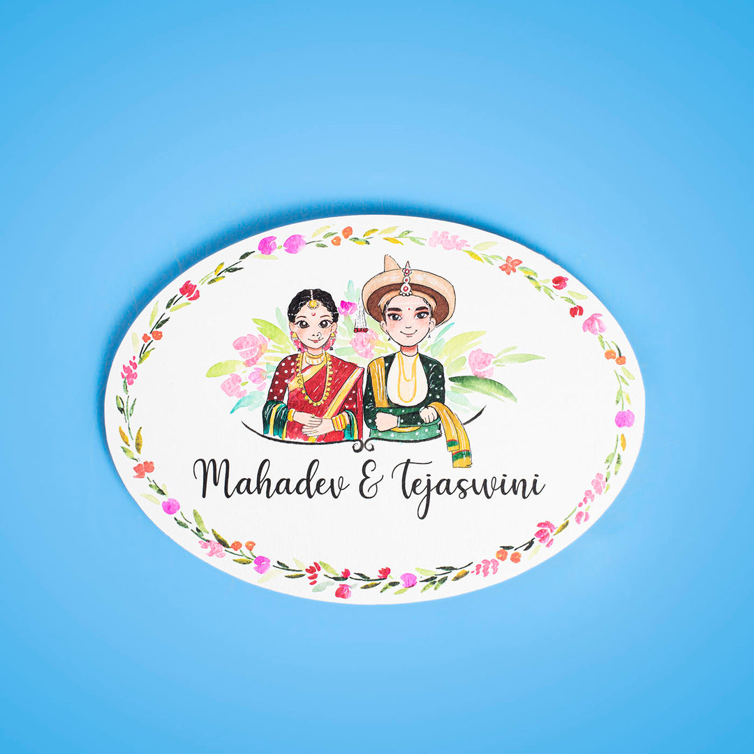 Oval Hand Painted Character Name Plate Marathi Couple - Front View on Blue Background