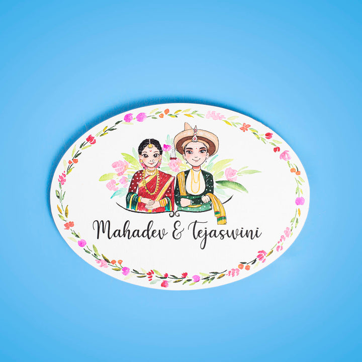 Oval Hand Painted Character Name Plate Marathi Couple - Front View on Blue Background