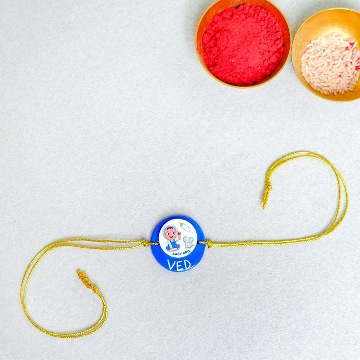 Handmade Personalized Rakhi Keychain With Roli Chawal 2 - Flat lay with festive items