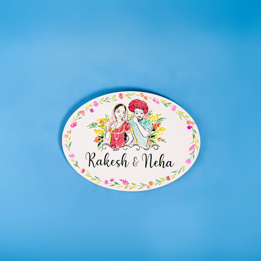 Oval Hand Painted Character Name Plate Rajasthani Couple - Top View on Blue Background