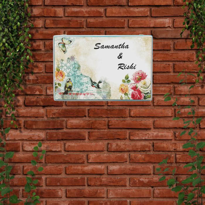 Decoupage Rectangle Couple Name Plate With Butterfly Artwork - Mounted on Brick Wall with Foliage