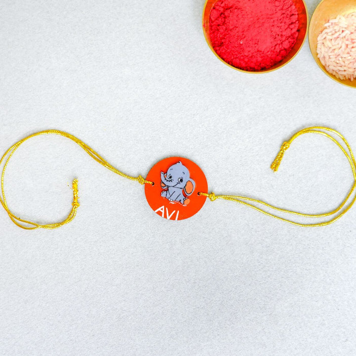 Handmade Personalized Rakhi Keychain With Roli Chawal 5 - Flat lay view with pooja items
